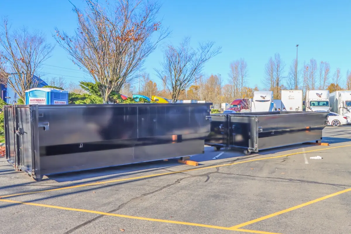 Professional dumpster rental service with roll-off container on residential driveway in Martin